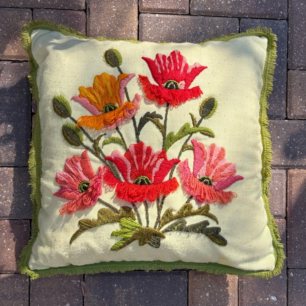 Embroidered floral print decorative pillow.